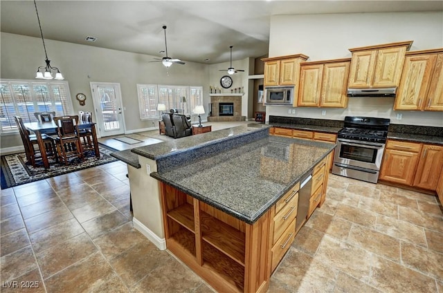 1361 Moose St, Pahrump, NV 89048 - kitchen with appliances with stainless steel finishes, under cabinet range hood, open shelves, a fireplace, and ceiling fan