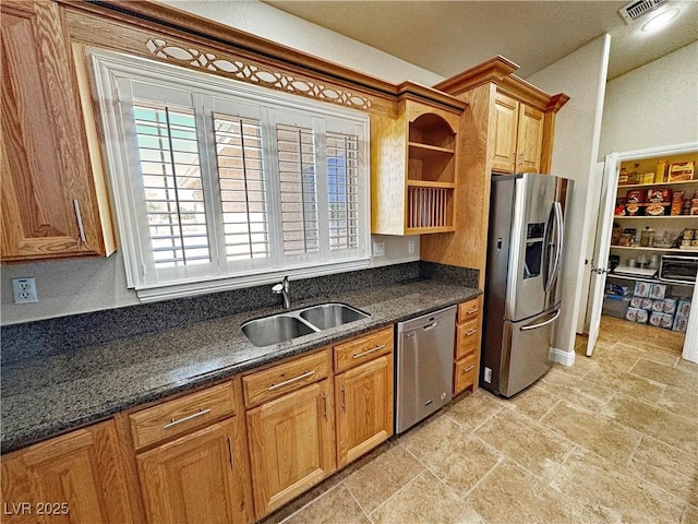 1361 Moose St, Pahrump, NV 89048 - kitchen featuring stainless steel appliances, a sink, open shelves, light stone finish floors, and dark stone counters