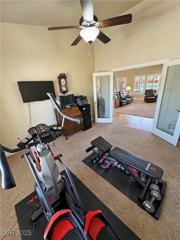 1361 Moose St, Pahrump, NV 89048 - exercise room featuring carpet floors, a ceiling fan, a towering ceiling, and tile patterned floors