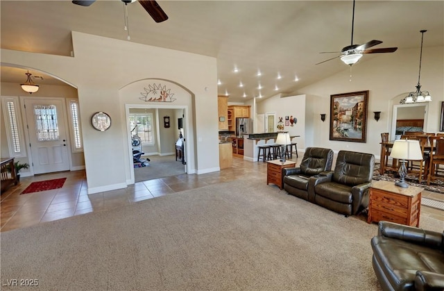 1361 Moose St, Pahrump, NV 89048 - carpeted living area featuring ceiling fan, tile patterned flooring, arched walkways, lofted ceiling, and baseboards