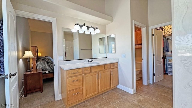 1361 Moose St, Pahrump, NV 89048 - ensuite bathroom featuring vanity, toilet, a walk in closet, and baseboards
