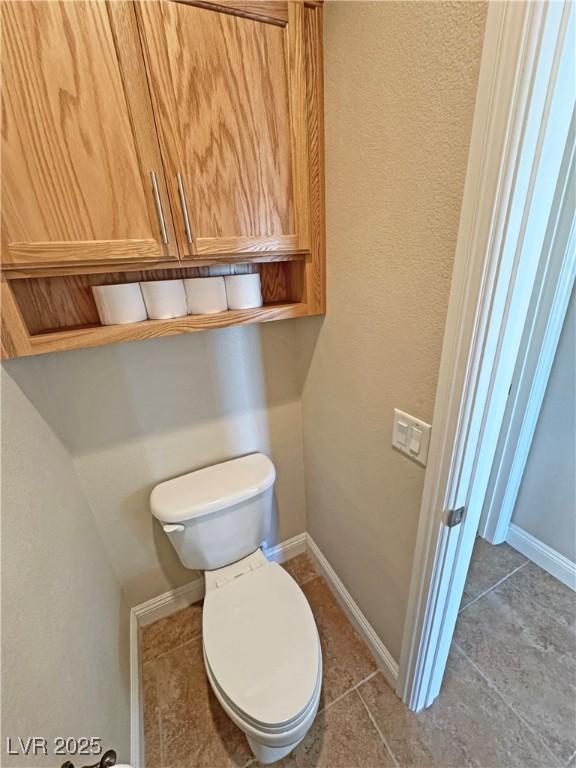 1361 Moose St, Pahrump, NV 89048 - bathroom featuring toilet, tile patterned floors, and baseboards