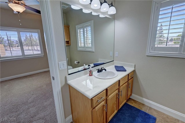 1361 Moose St, Pahrump, NV 89048 - bathroom featuring plenty of natural light, vanity, ceiling fan, and baseboards