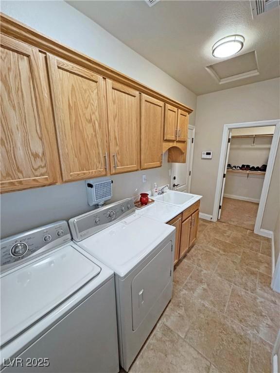 1361 Moose St, Pahrump, NV 89048 - washroom with attic access, washer and clothes dryer, cabinet space, light stone finish floors, and baseboards