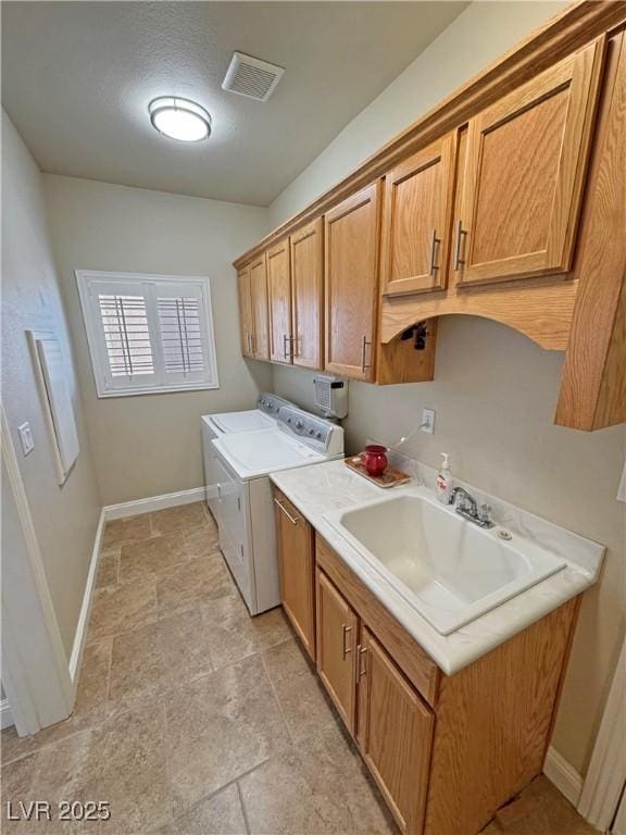 1361 Moose St, Pahrump, NV 89048 - laundry room featuring cabinet space, separate washer and dryer, baseboards, and light stone finish floors
