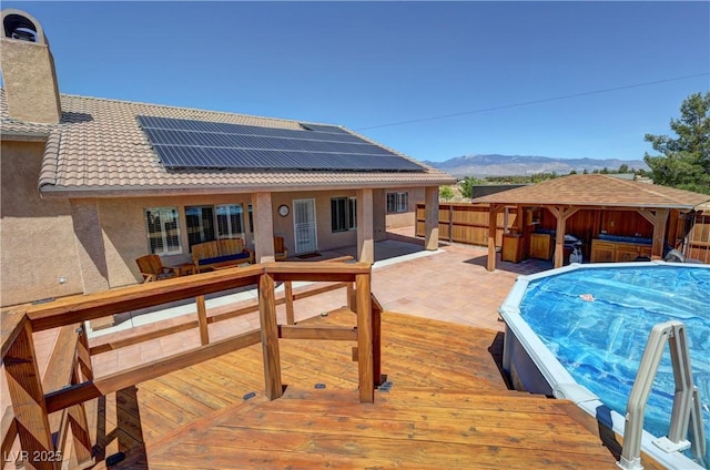 1361 Moose St, Pahrump, NV 89048 - view of pool featuring a jacuzzi, a deck with mountain view, a gazebo, and a patio area