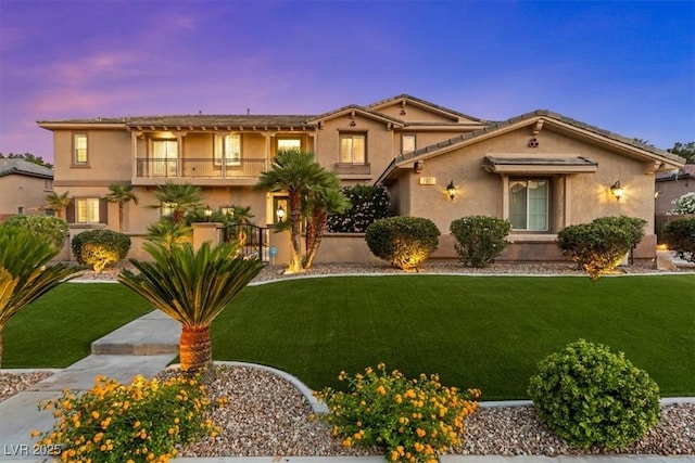 7001 Via Locanda Ave, Las Vegas, NV 89131 - view of front of home with a balcony, a front lawn, and stucco siding