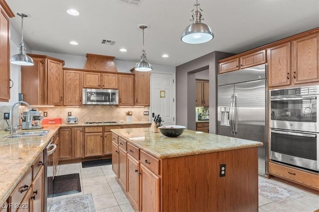 7001 Via Locanda Ave, Las Vegas, NV 89131 - kitchen featuring appliances with stainless steel finishes, a sink, a center island, light tile patterned floors, and recessed lighting