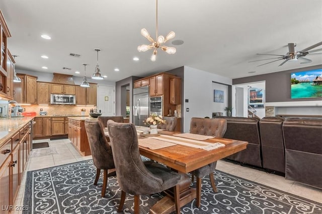 7001 Via Locanda Ave, Las Vegas, NV 89131 - dining area featuring light tile patterned floors, a chandelier, recessed lighting, and a ceiling fan