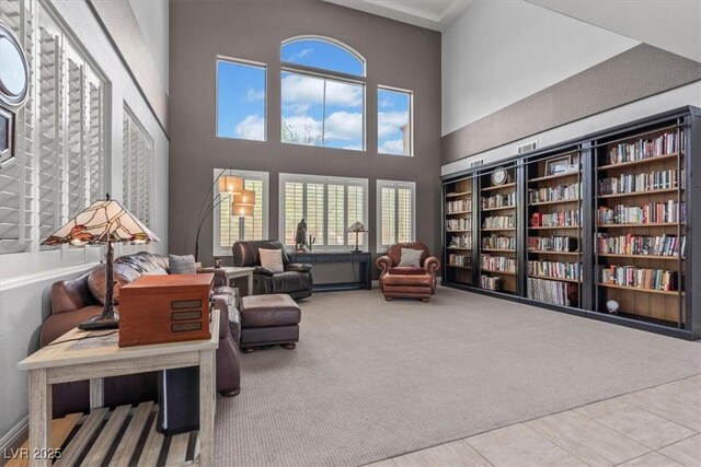 7001 Via Locanda Ave, Las Vegas, NV 89131 - living area with carpet flooring, tile patterned floors, and a high ceiling
