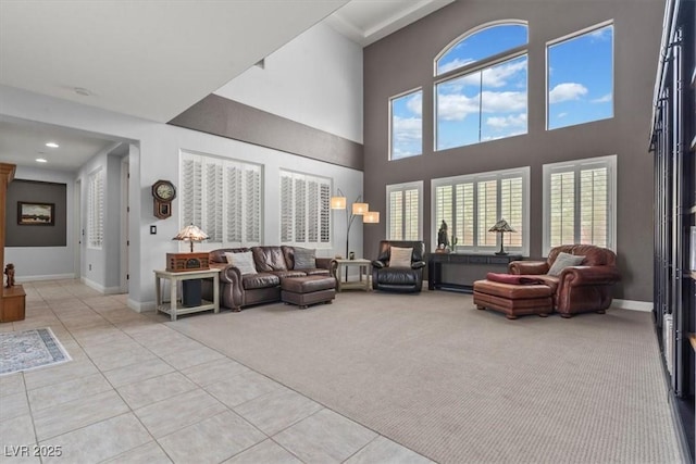 7001 Via Locanda Ave, Las Vegas, NV 89131 - living room featuring light colored carpet, light tile patterned flooring, a towering ceiling, baseboards, and recessed lighting