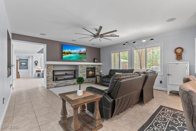 7001 Via Locanda Ave, Las Vegas, NV 89131 - living room featuring a fireplace, light tile patterned floors, a ceiling fan, and baseboards