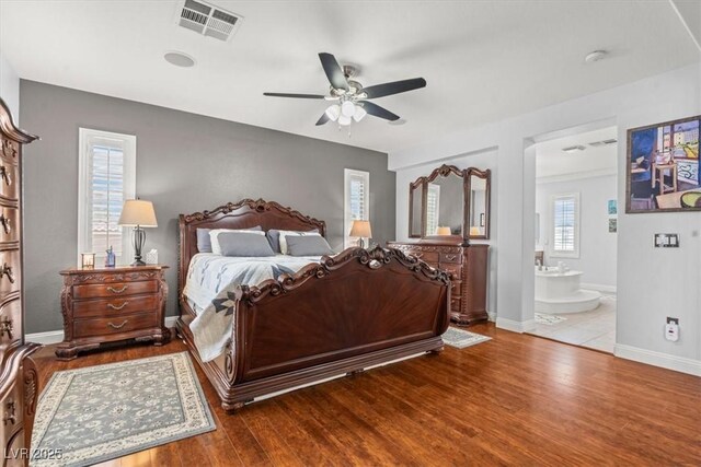 7001 Via Locanda Ave, Las Vegas, NV 89131 - bedroom with wood finished floors, ensuite bath, baseboards, and ceiling fan