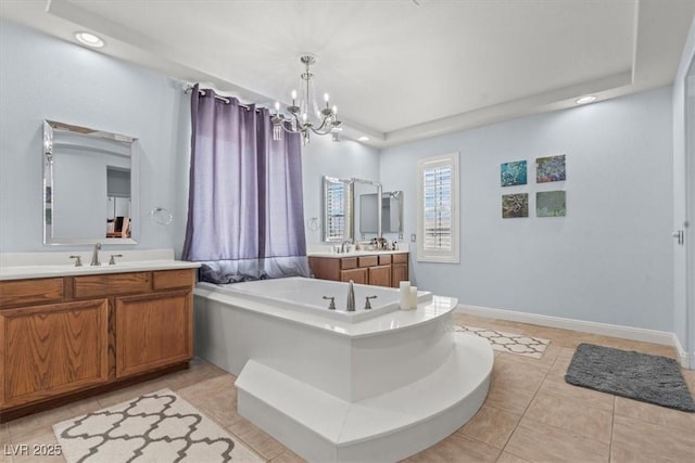7001 Via Locanda Ave, Las Vegas, NV 89131 - bathroom featuring a tub to relax in, a chandelier, two vanities, tile patterned floors, and recessed lighting