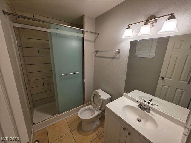 5440 Swenson St Unit 18, Las Vegas, NV 89119 - bathroom featuring a stall shower, toilet, vanity, and tile patterned floors