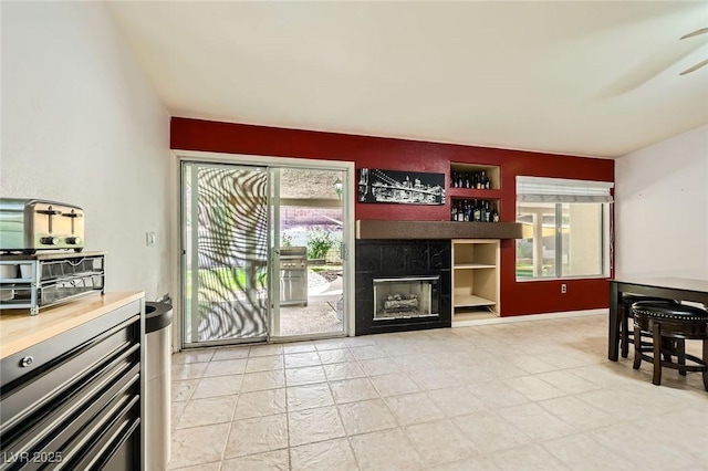 1905 Dakota Hills Ave, Las Vegas, NV 89123 - living area with a tiled fireplace, plenty of natural light, and ceiling fan