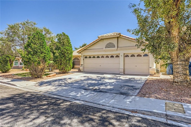 1905 Dakota Hills Ave, Las Vegas, NV 89123 - view of front of house featuring an attached garage, concrete driveway, stucco siding, and a tile roof