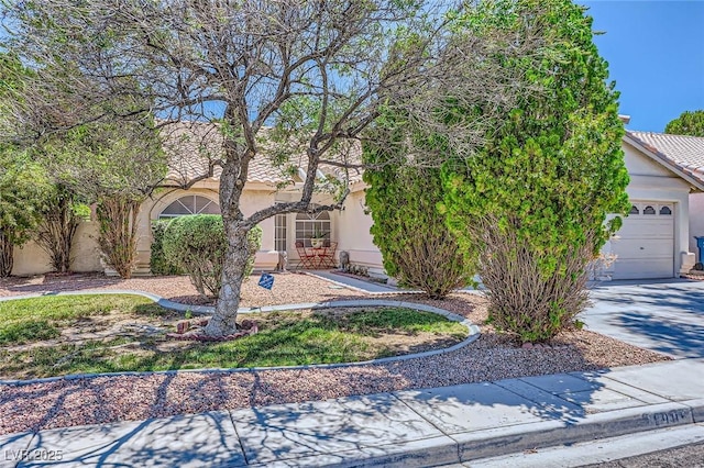 1905 Dakota Hills Ave, Las Vegas, NV 89123 - obstructed view of property featuring stucco siding, driveway, a garage, and a tiled roof