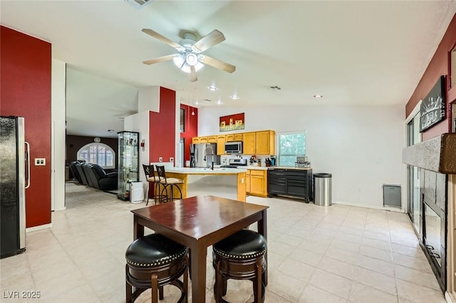 1905 Dakota Hills Ave, Las Vegas, NV 89123 - dining room with lofted ceiling, a glass covered fireplace, and ceiling fan