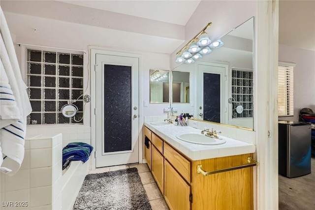 1905 Dakota Hills Ave, Las Vegas, NV 89123 - bathroom with double vanity, a garden tub, and tile patterned flooring