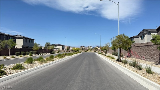 2924 Sunday Silence Rd, North Las Vegas, NV 89086 - view of asphalt road with a residential view, street lighting, and curbs
