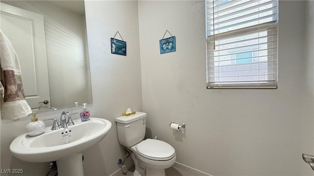 2924 Sunday Silence Rd, North Las Vegas, NV 89086 - bathroom with toilet, a sink, and baseboards