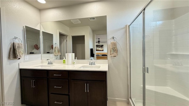 2924 Sunday Silence Rd, North Las Vegas, NV 89086 - bathroom featuring a textured wall, a shower stall, and double vanity