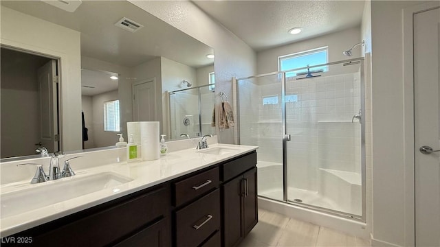 2924 Sunday Silence Rd, North Las Vegas, NV 89086 - full bathroom featuring a stall shower, double vanity, a textured ceiling, tile patterned flooring, and recessed lighting