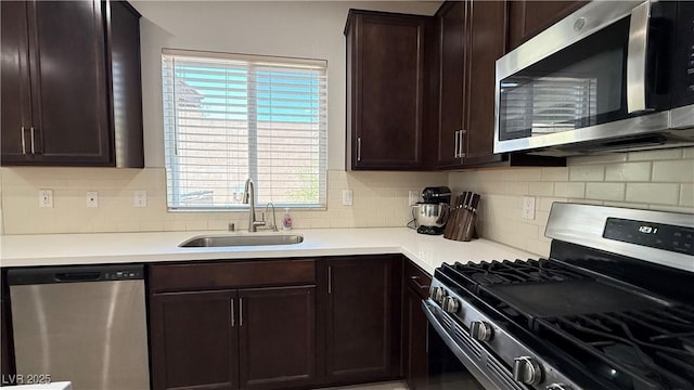2924 Sunday Silence Rd, North Las Vegas, NV 89086 - kitchen featuring stainless steel appliances, a sink, healthy amount of natural light, and dark brown cabinets