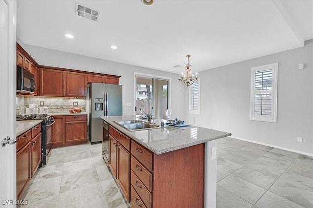 4020 Recktenwall Ave, North Las Vegas, NV 89081 - kitchen featuring black appliances, a sink, a chandelier, a kitchen island with sink, and backsplash