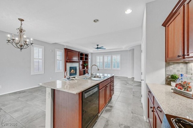 4020 Recktenwall Ave, North Las Vegas, NV 89081 - kitchen featuring black dishwasher, a sink, a warm lit fireplace, backsplash, and open floor plan
