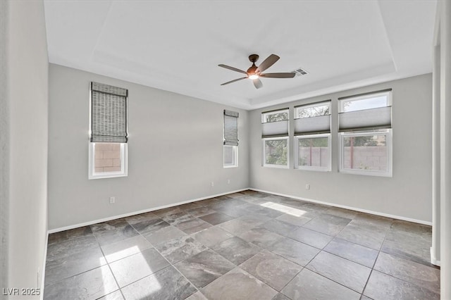 4020 Recktenwall Ave, North Las Vegas, NV 89081 - spare room featuring a raised ceiling, baseboards, and a ceiling fan