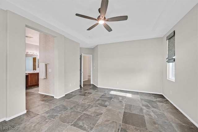 4020 Recktenwall Ave, North Las Vegas, NV 89081 - unfurnished bedroom featuring dark stone finish flooring, baseboards, ensuite bath, and a ceiling fan