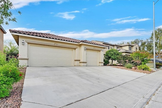 4020 Recktenwall Ave, North Las Vegas, NV 89081 - mediterranean / spanish home with a tile roof, stucco siding, concrete driveway, and a garage