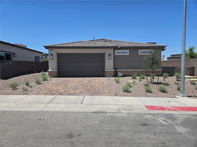 289 Aravalli Crest St, Henderson, NV 89015 - view of front of home featuring decorative driveway, a garage, and stucco siding
