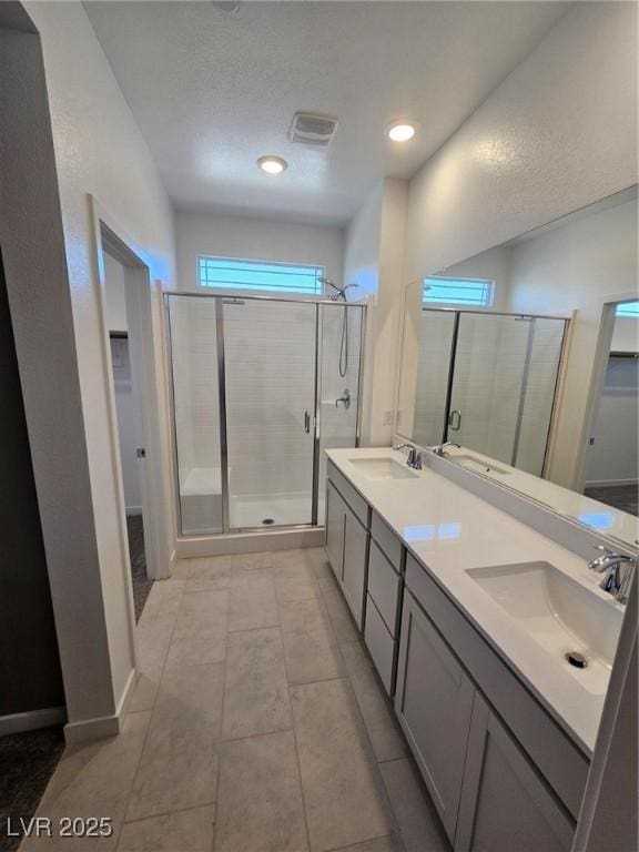 289 Aravalli Crest St, Henderson, NV 89015 - bathroom with a shower stall, double vanity, a spacious closet, recessed lighting, and tile patterned flooring