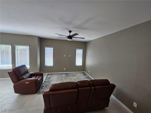 289 Aravalli Crest St, Henderson, NV 89015 - living area featuring baseboards, ceiling fan, light tile patterned floors, and a textured ceiling