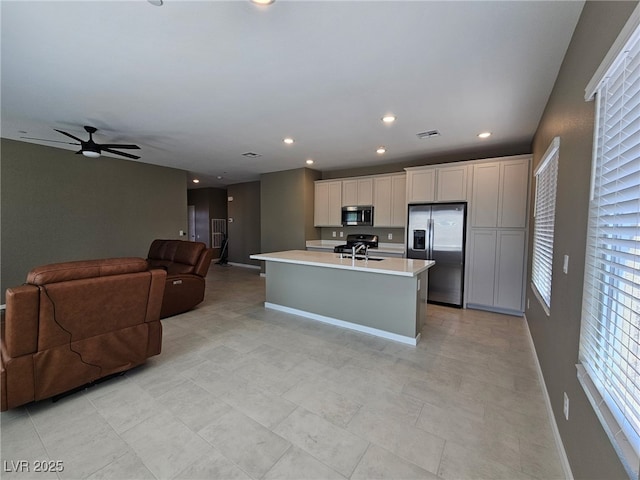 289 Aravalli Crest St, Henderson, NV 89015 - kitchen with appliances with stainless steel finishes, baseboards, open floor plan, light countertops, and a ceiling fan