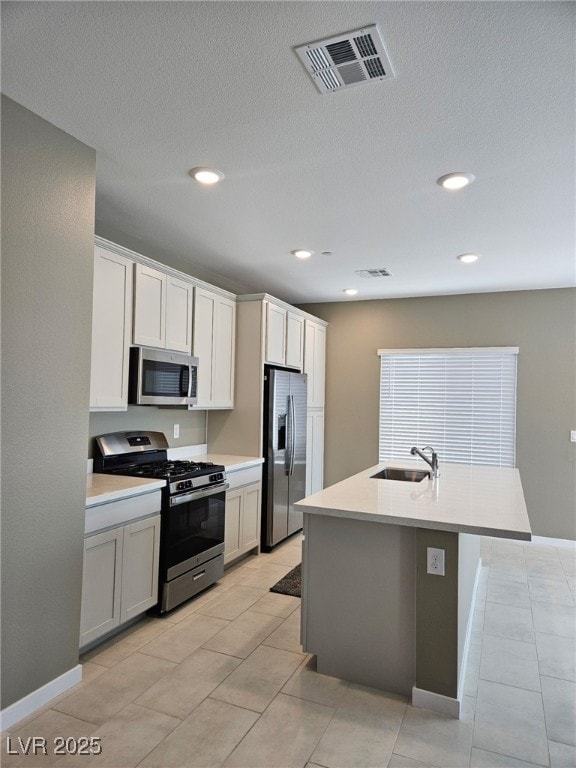 289 Aravalli Crest St, Henderson, NV 89015 - kitchen with stainless steel appliances, a sink, light countertops, recessed lighting, and an island with sink