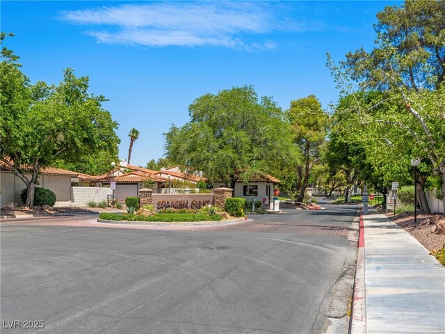 2104 Plaza De La Candela, Las Vegas, NV 89102 - view of asphalt road featuring curbs, a gated entry, and sidewalks