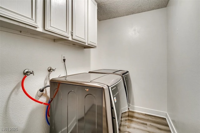 864 E Eldorado Ln, Las Vegas, NV 89123 - laundry room featuring wood finished floors, cabinet space, baseboards, washer and clothes dryer, and a textured ceiling