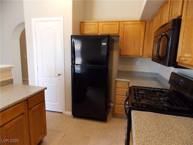 319 Mulberry Glen Dr, North Las Vegas, NV 89031 - kitchen with black appliances, arched walkways, light tile patterned flooring, and light countertops