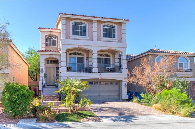 6714 Flamenco Ct, Las Vegas, NV 89139 - mediterranean / spanish house featuring stucco siding, a tiled roof, decorative driveway, an attached garage, and a balcony