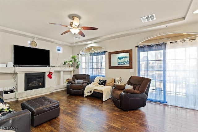 6714 Flamenco Ct, Las Vegas, NV 89139 - living area with ceiling fan, wood finished floors, a high end fireplace, and a raised ceiling