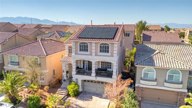 6714 Flamenco Ct, Las Vegas, NV 89139 - mediterranean / spanish-style house featuring a garage, a mountain view, stucco siding, and a balcony