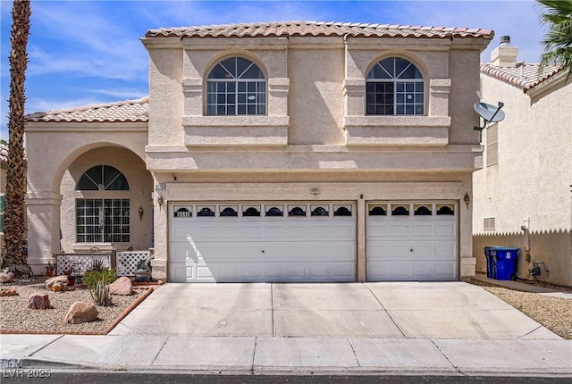 8116 Kokoma Dr, Las Vegas, NV 89128 - mediterranean / spanish house featuring a garage, concrete driveway, stucco siding, and a tile roof
