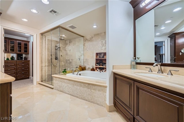 9103 Alta Dr Unit 407, Las Vegas, NV 89145 - full bathroom featuring vanity, a stall shower, a bath, and recessed lighting