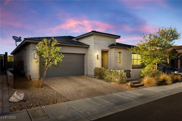 11672 Barga Ct, Las Vegas, NV 89138 - view of front of home with decorative driveway, a garage, stone siding, and stucco siding