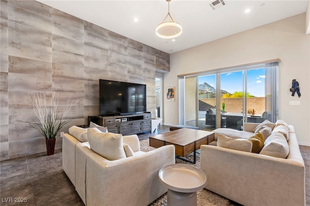 11672 Barga Ct, Las Vegas, NV 89138 - living room featuring an accent wall, baseboards, recessed lighting, and tile walls