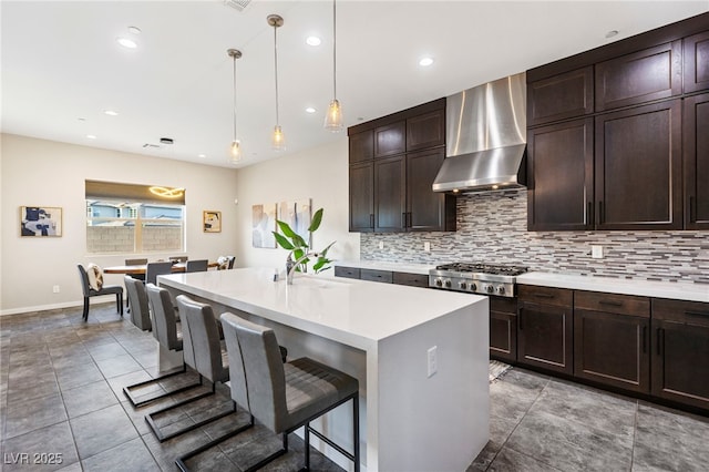 11672 Barga Ct, Las Vegas, NV 89138 - kitchen featuring wall chimney range hood, stainless steel gas cooktop, tasteful backsplash, light countertops, and recessed lighting